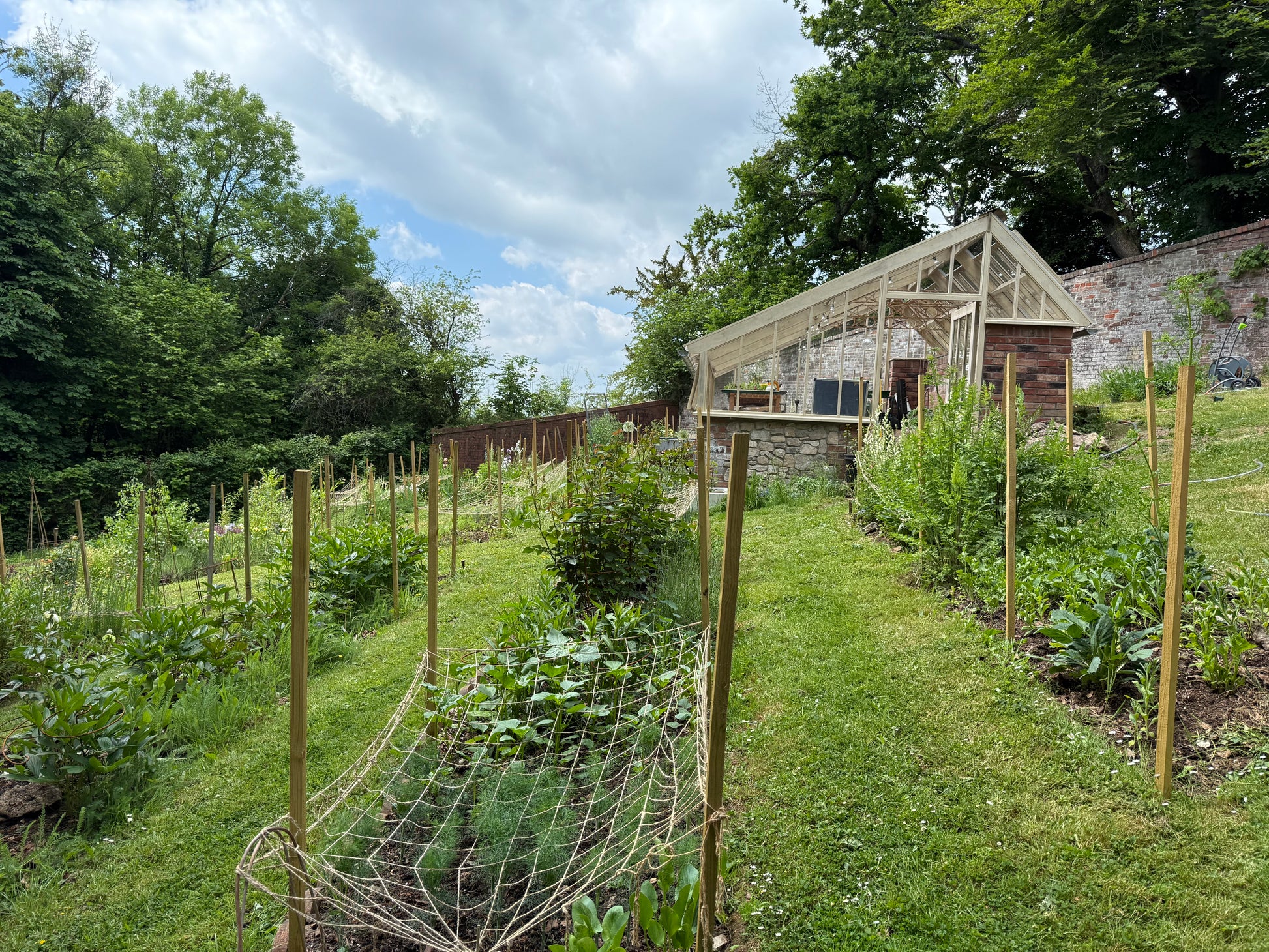 Flower farm with growing beds and greenhouse